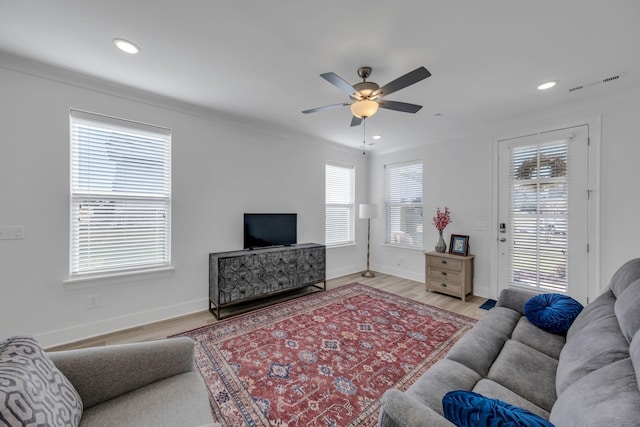 living area featuring recessed lighting, visible vents, baseboards, and wood finished floors