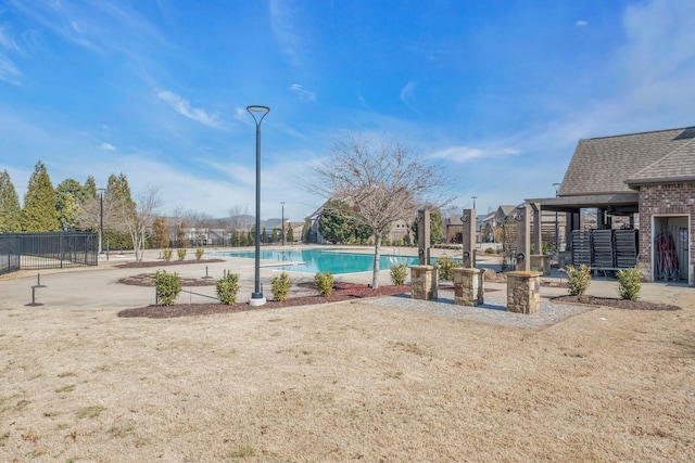 pool featuring fence and a patio