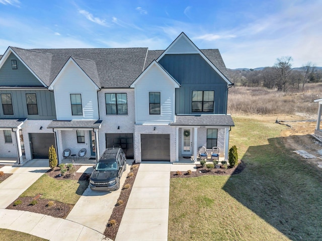 view of front of house with driveway, a porch, board and batten siding, and a front yard