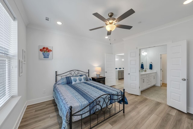 bedroom featuring ornamental molding, visible vents, and light wood finished floors