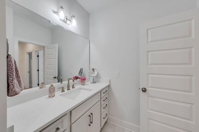 bathroom featuring marble finish floor, vanity, and baseboards