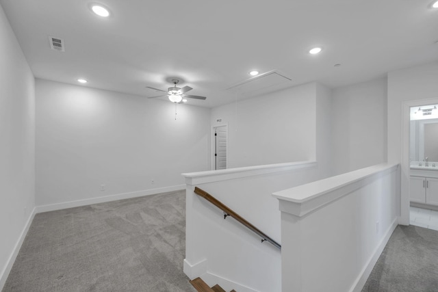 corridor featuring recessed lighting, light colored carpet, visible vents, an upstairs landing, and attic access