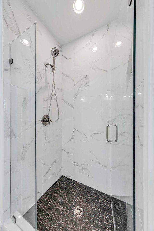 full bathroom featuring a marble finish shower