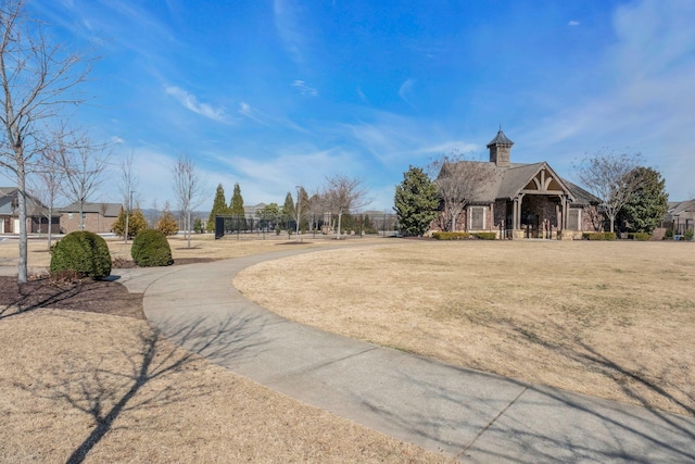 view of property's community featuring fence and a lawn