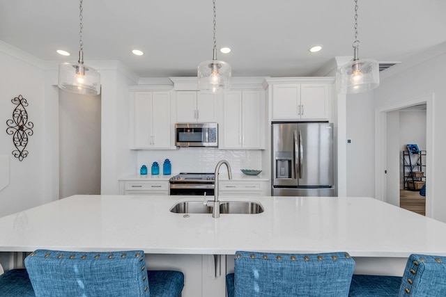 kitchen with a large island, stainless steel appliances, light countertops, and decorative light fixtures