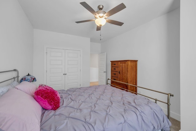 bedroom featuring ceiling fan, a closet, and light carpet