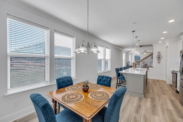 dining room featuring baseboards, light wood finished floors, stairway, and recessed lighting