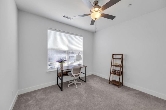 office with a ceiling fan, light colored carpet, visible vents, and baseboards