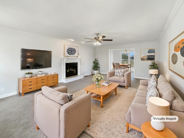 living area featuring a fireplace with raised hearth, ceiling fan, light carpet, and baseboards