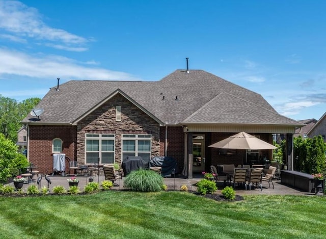 rear view of house with brick siding, roof with shingles, and a patio area