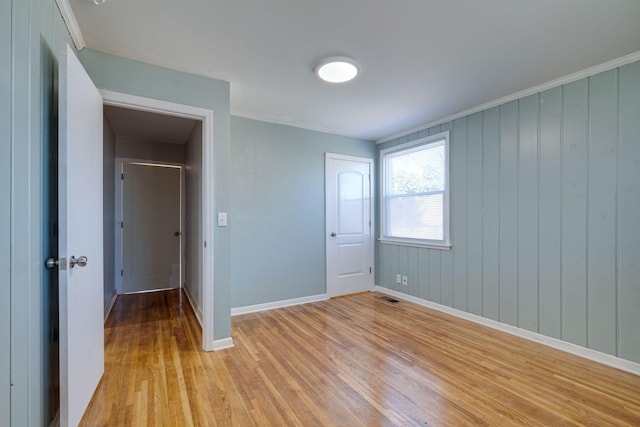 unfurnished bedroom featuring visible vents, light wood-style flooring, and baseboards