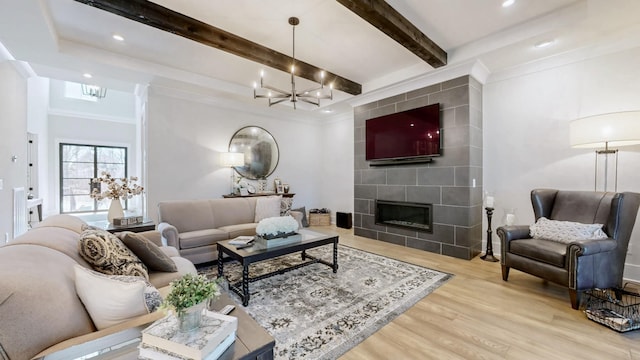 living room featuring crown molding, a fireplace, wood finished floors, a chandelier, and beamed ceiling