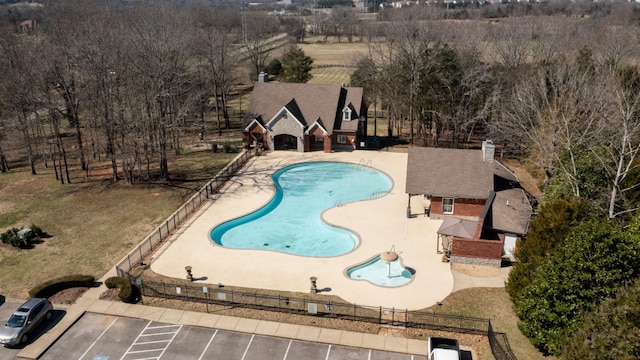 view of pool with a patio and fence