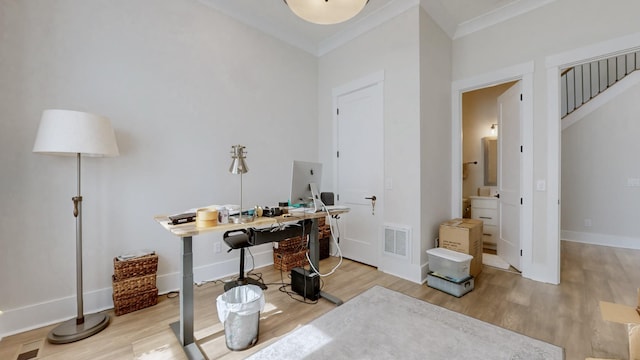 office area with baseboards, crown molding, visible vents, and wood finished floors