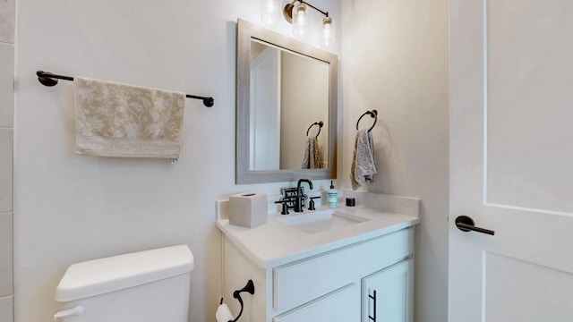 bathroom with toilet and vanity