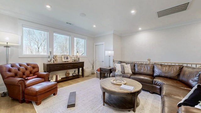 living area featuring ornamental molding, recessed lighting, visible vents, and wood finished floors