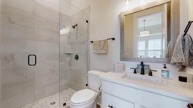 full bath with toilet, a shower stall, and vanity