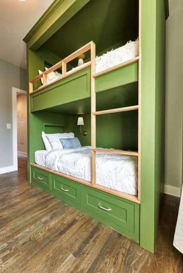 unfurnished bedroom with dark wood-style floors and baseboards