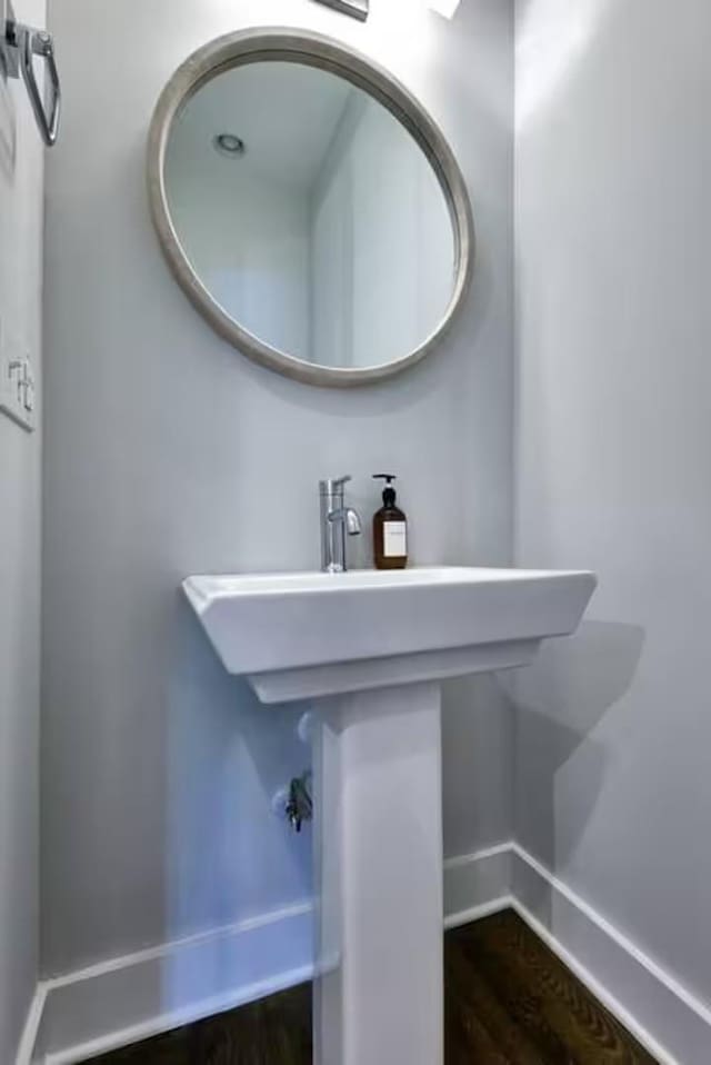 bathroom with baseboards and wood finished floors