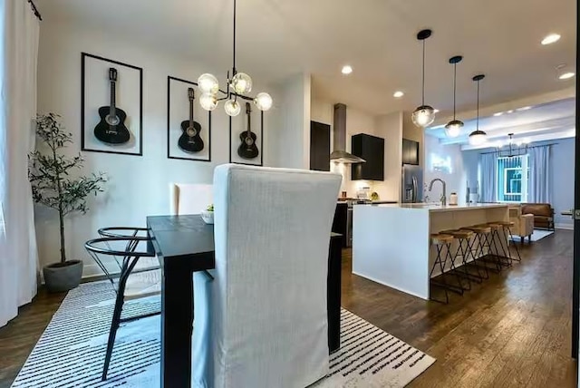 dining room with recessed lighting, dark wood-style flooring, and an inviting chandelier