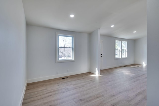 empty room with visible vents, recessed lighting, light wood-style flooring, and baseboards