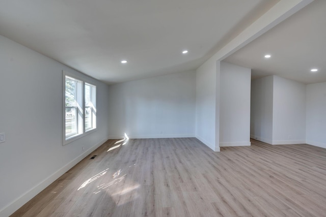 unfurnished room with visible vents, recessed lighting, light wood-style flooring, and baseboards