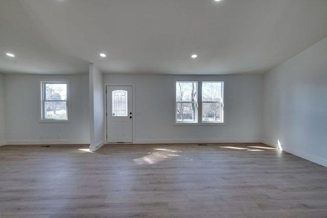 foyer with baseboards, recessed lighting, and light wood-style floors