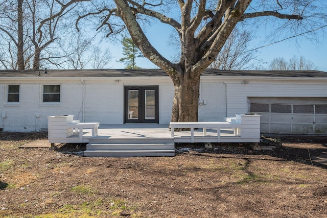 back of house with a deck and brick siding