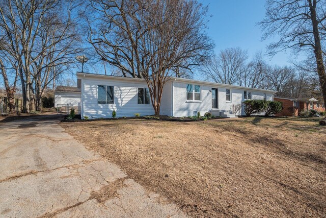 single story home with brick siding and a front lawn