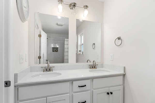 bathroom with double vanity, a sink, and a shower with curtain