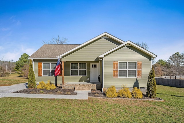 view of front of home with crawl space, roof with shingles, fence, and a front yard