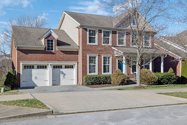 view of front of home featuring a garage, a shingled roof, concrete driveway, and brick siding