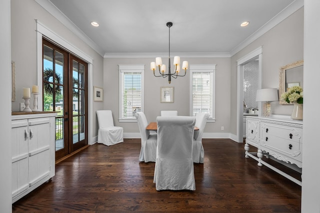 dining area featuring dark wood-style flooring, crown molding, and french doors