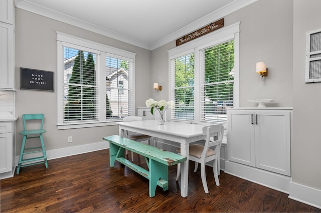 dining room featuring crown molding, plenty of natural light, dark wood finished floors, and baseboards