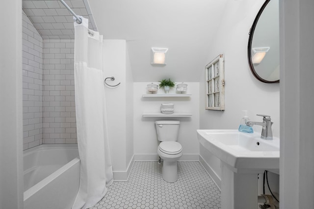 bathroom with toilet, shower / tub combo, a sink, baseboards, and tile patterned floors