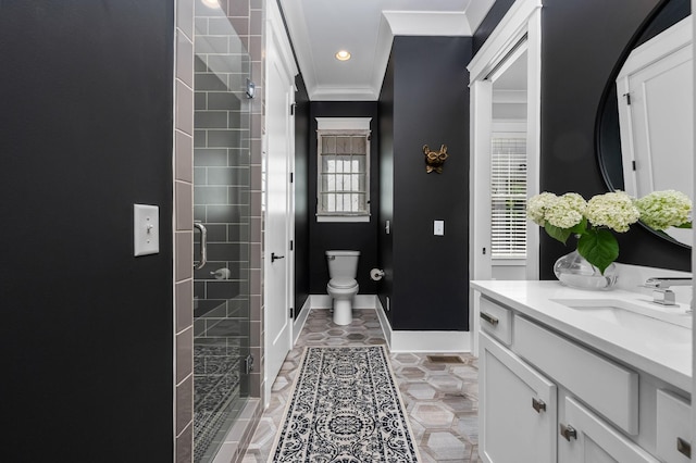 bathroom with toilet, vanity, baseboards, ornamental molding, and a shower stall