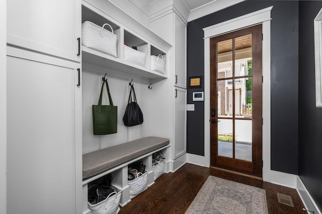 mudroom featuring dark wood-style floors, visible vents, and baseboards