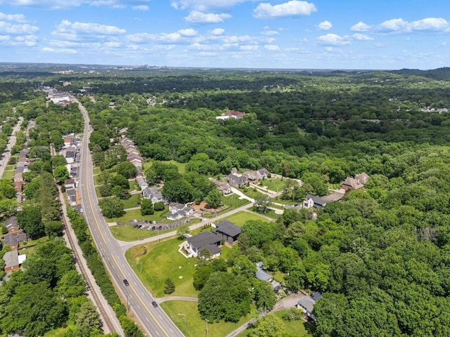 drone / aerial view with a wooded view and a residential view