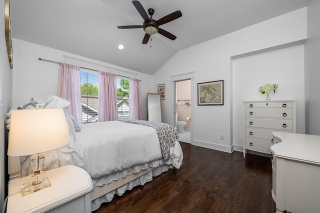 bedroom with baseboards, a ceiling fan, lofted ceiling, ensuite bath, and dark wood-type flooring