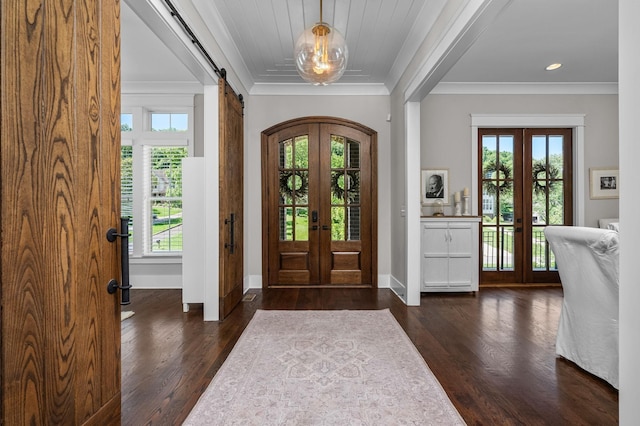 foyer with crown molding, dark wood finished floors, french doors, and plenty of natural light