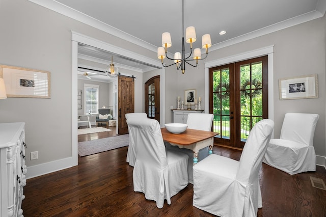 dining space featuring arched walkways, a barn door, dark wood-style flooring, visible vents, and crown molding