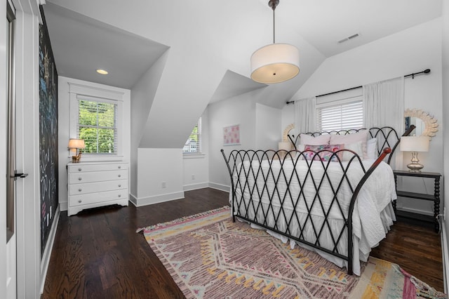 bedroom with lofted ceiling, multiple windows, and visible vents