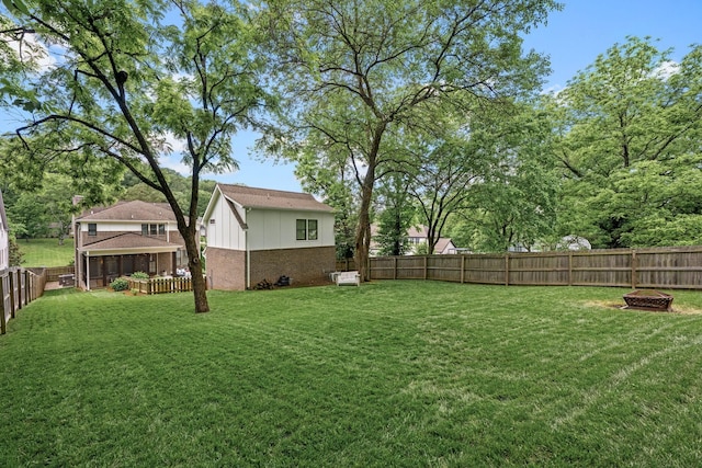 view of yard featuring an outdoor fire pit and a fenced backyard