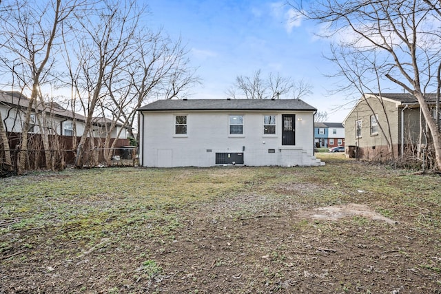 rear view of property with fence, central AC unit, and brick siding