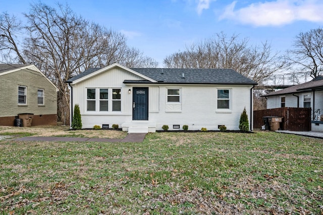 view of front of house featuring entry steps, crawl space, brick siding, and a front yard