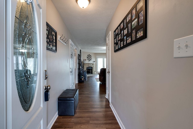 hallway with baseboards and dark wood-type flooring