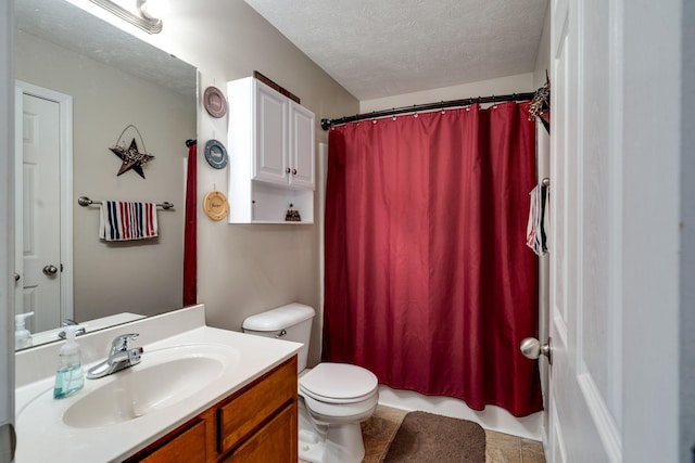 bathroom featuring toilet, a textured ceiling, and vanity