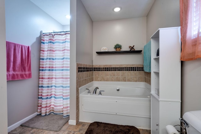 bathroom with curtained shower, a garden tub, toilet, and baseboards