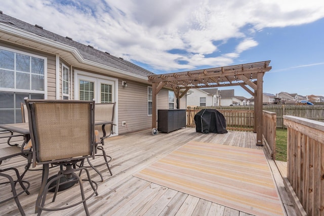 deck featuring a grill, fence, and a pergola