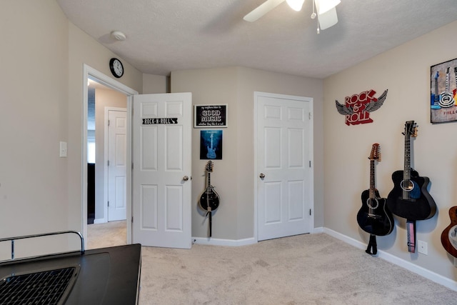 carpeted bedroom featuring ceiling fan, baseboards, and a textured ceiling